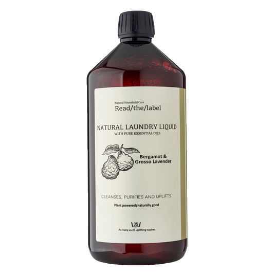 Natural laundry liquid in amber bottle with bergamot and lavender label, vegan and eco-friendly.