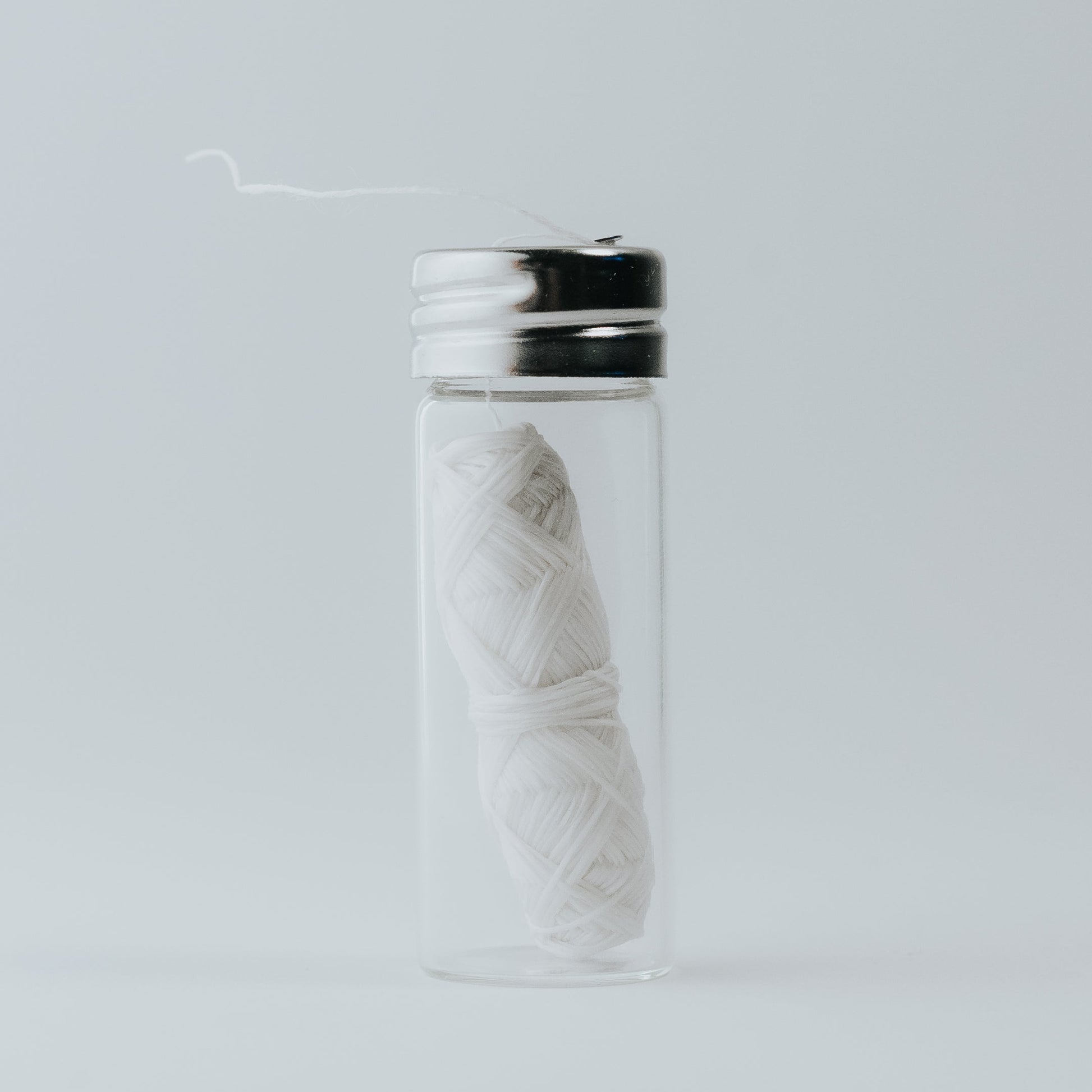 Roll of natural silk dental floss, compostable and gentle on gums, eco-friendly.