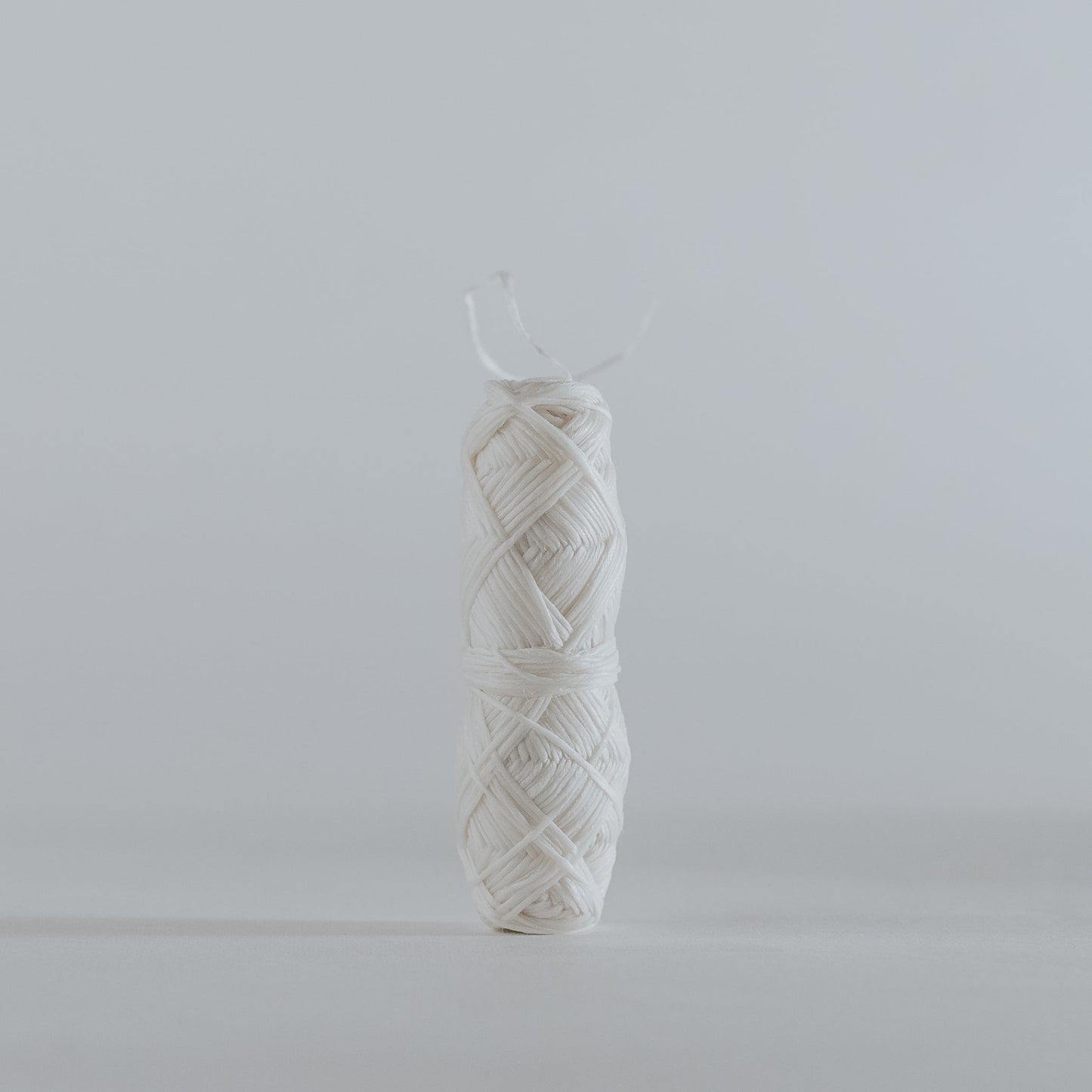 Close-up of natural silk dental floss roll, biodegradable and plastic-free.