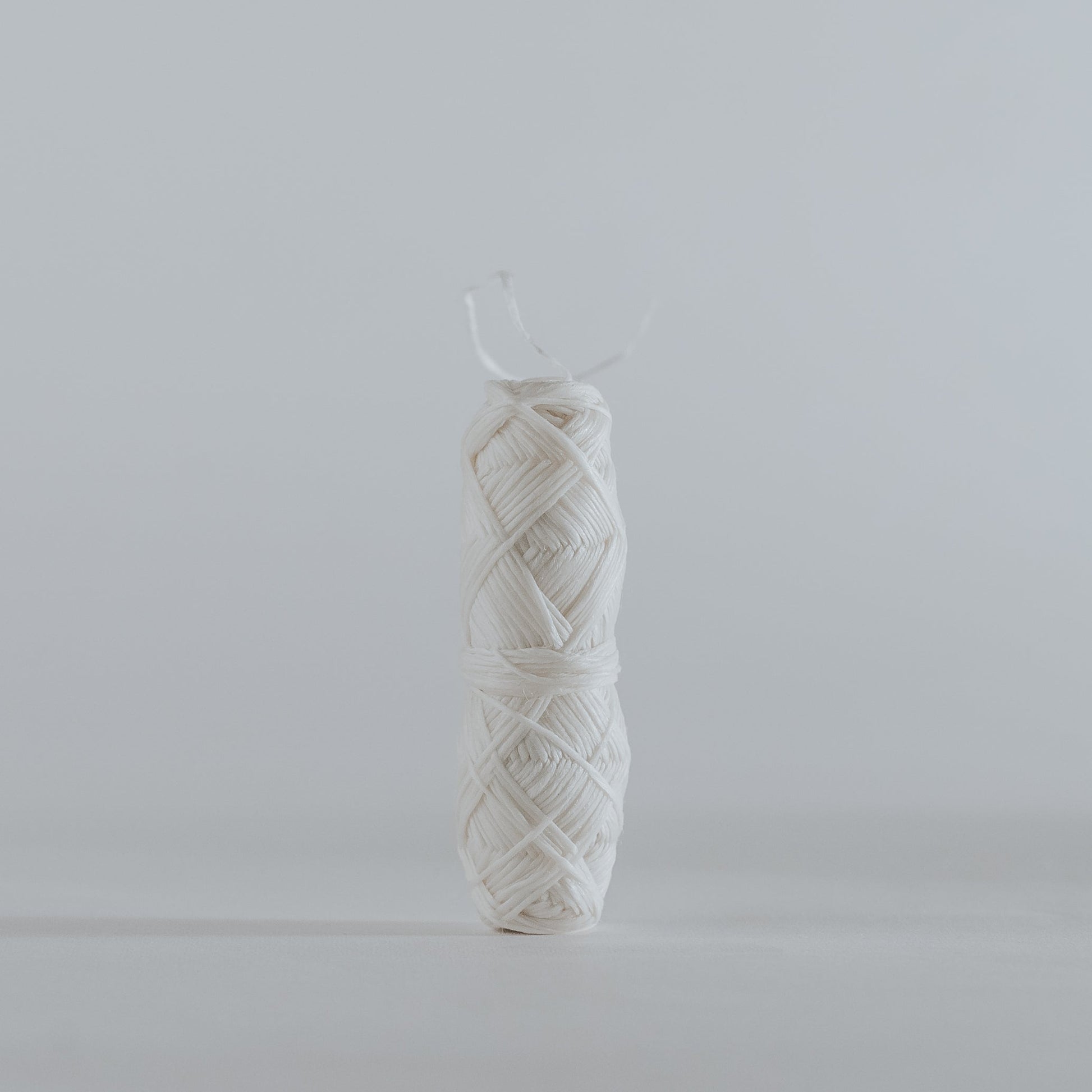 Close-up of natural silk dental floss roll, biodegradable and plastic-free.